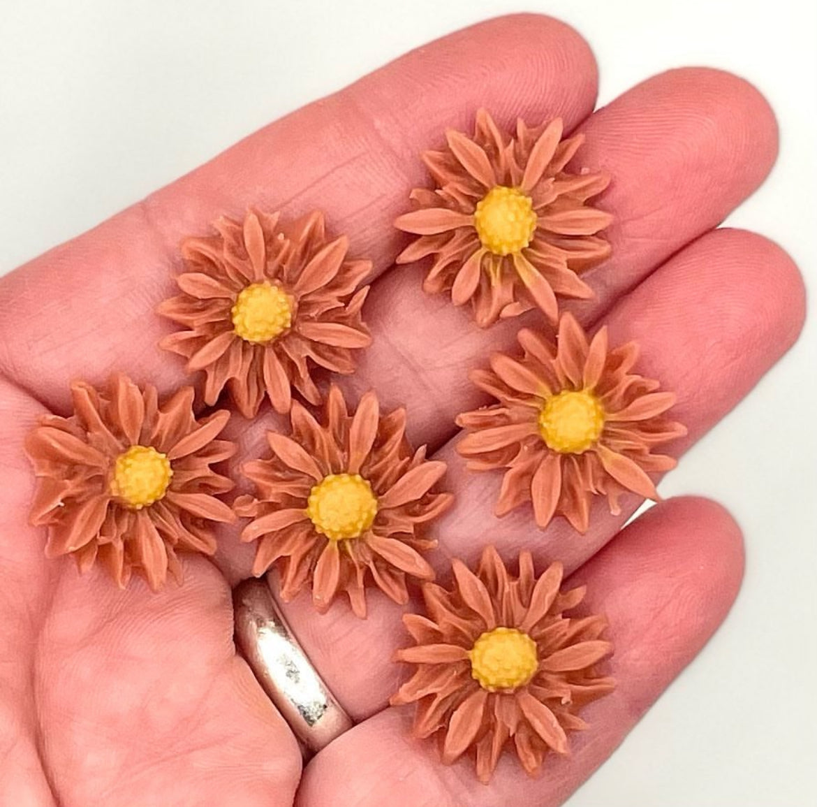 hand holding small soap dough flowers