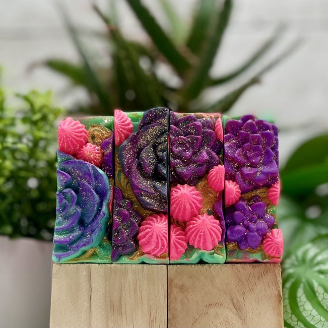 sweet succulent coconut milk soaps. close up of soap top with hand pressed and piped succulent decorations