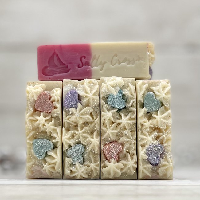 stack of candy heart artisan soaps with Salty Crossing brand stamped on side