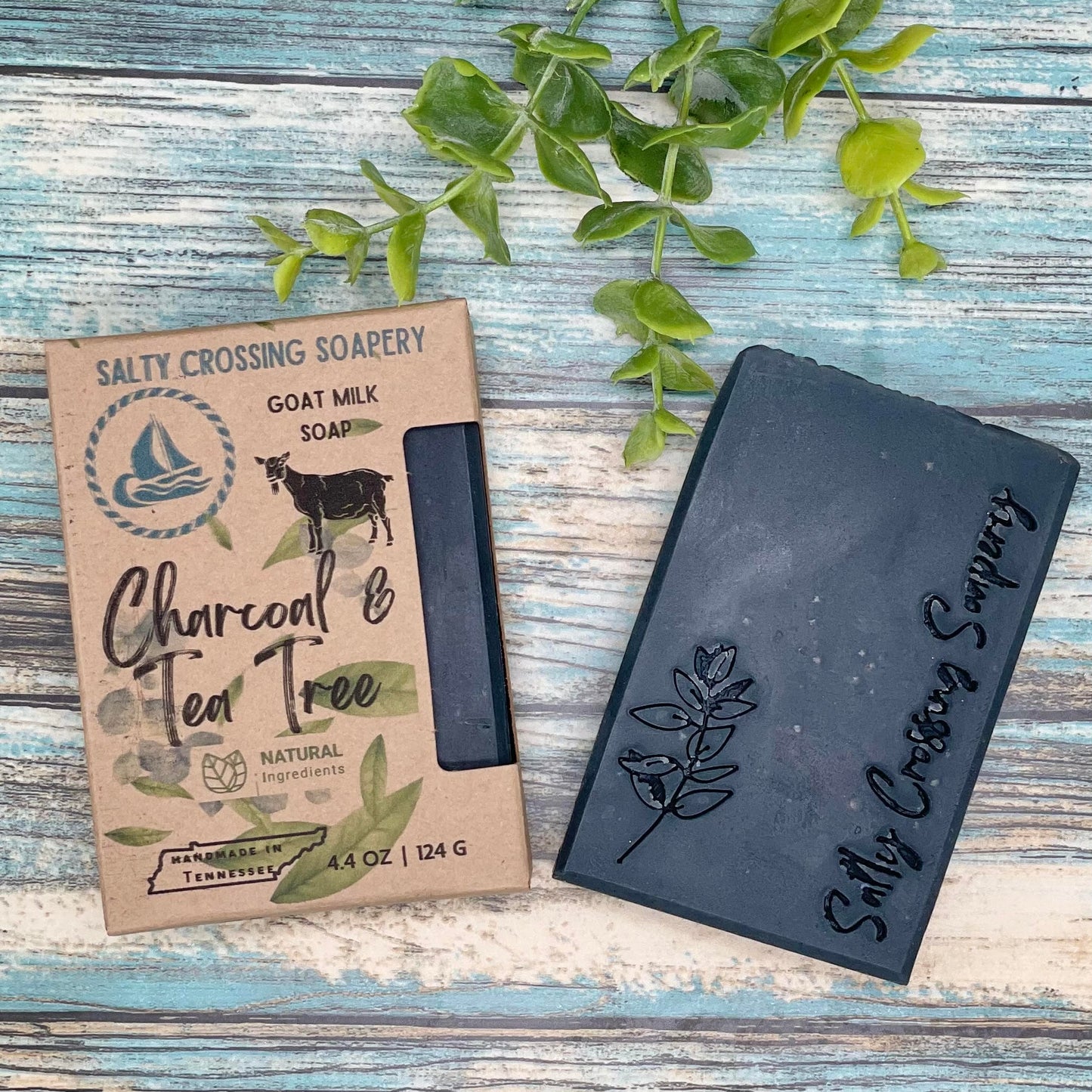 Charcoal and tea tree goat milk soap with box. Pure black soap stamped with plant graphic and salty crossing Soapery text