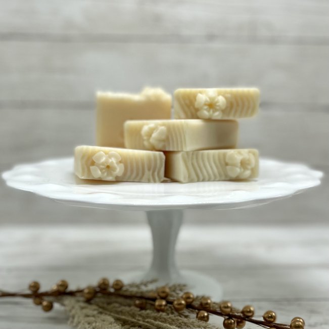 stack of fancy white soaps on cake stand