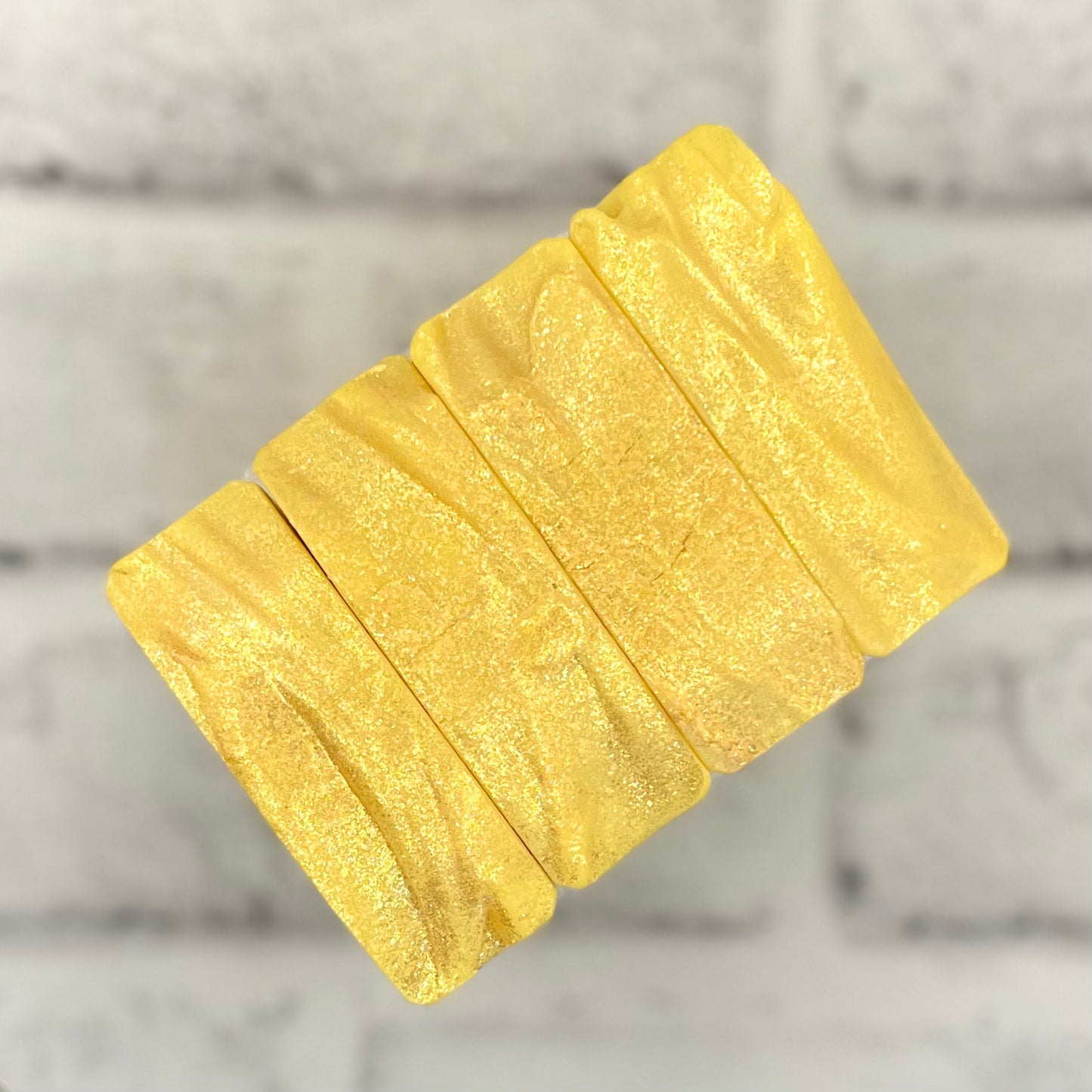 row of yellow soap tops with gold sparkles