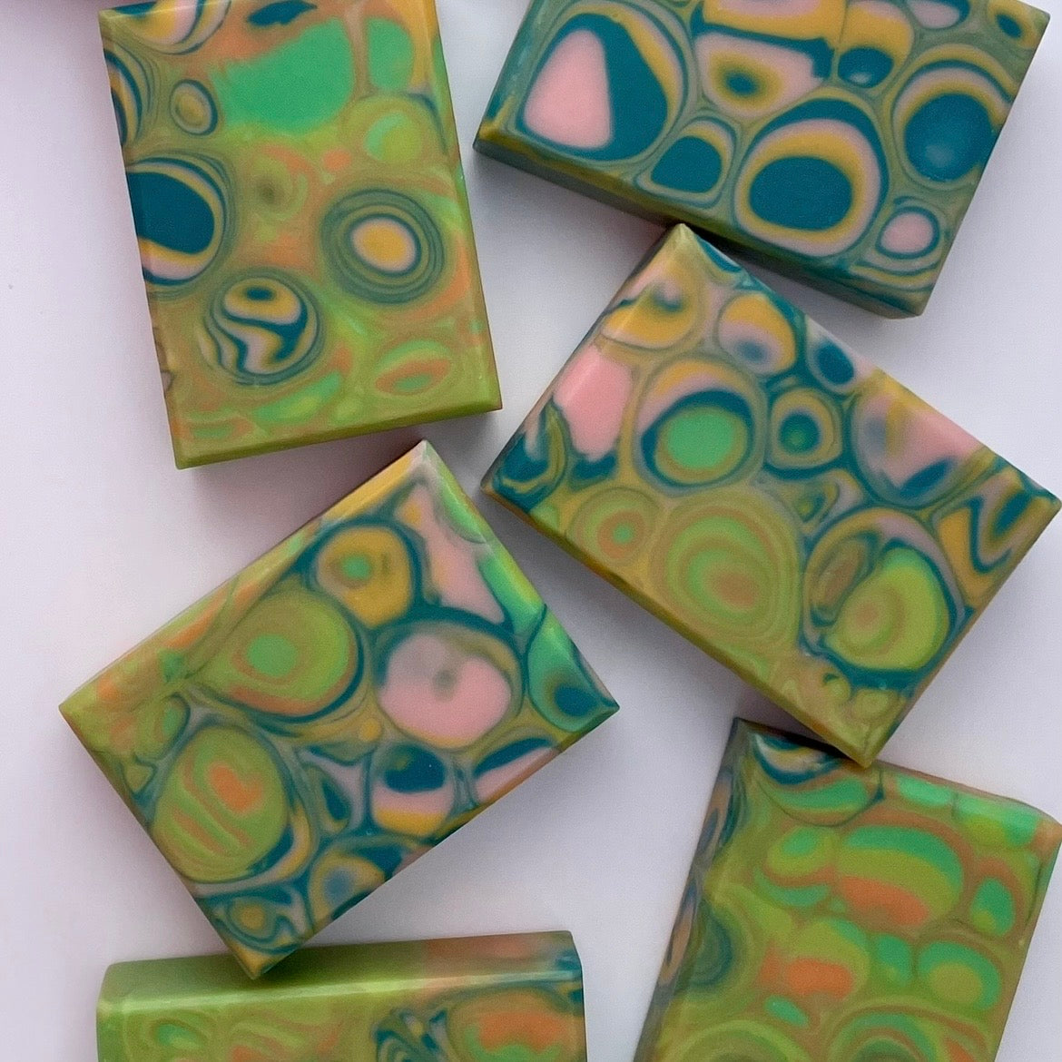 Colorful soap bars with circular patterns on a white background