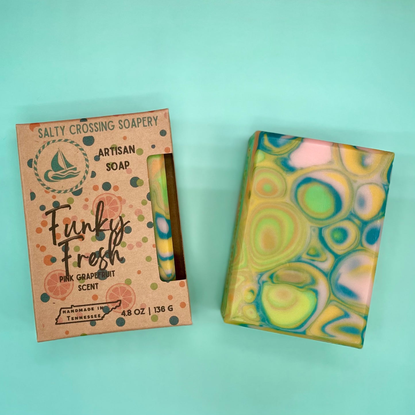 Artisan soap with a colorful packaging box on a light blue background