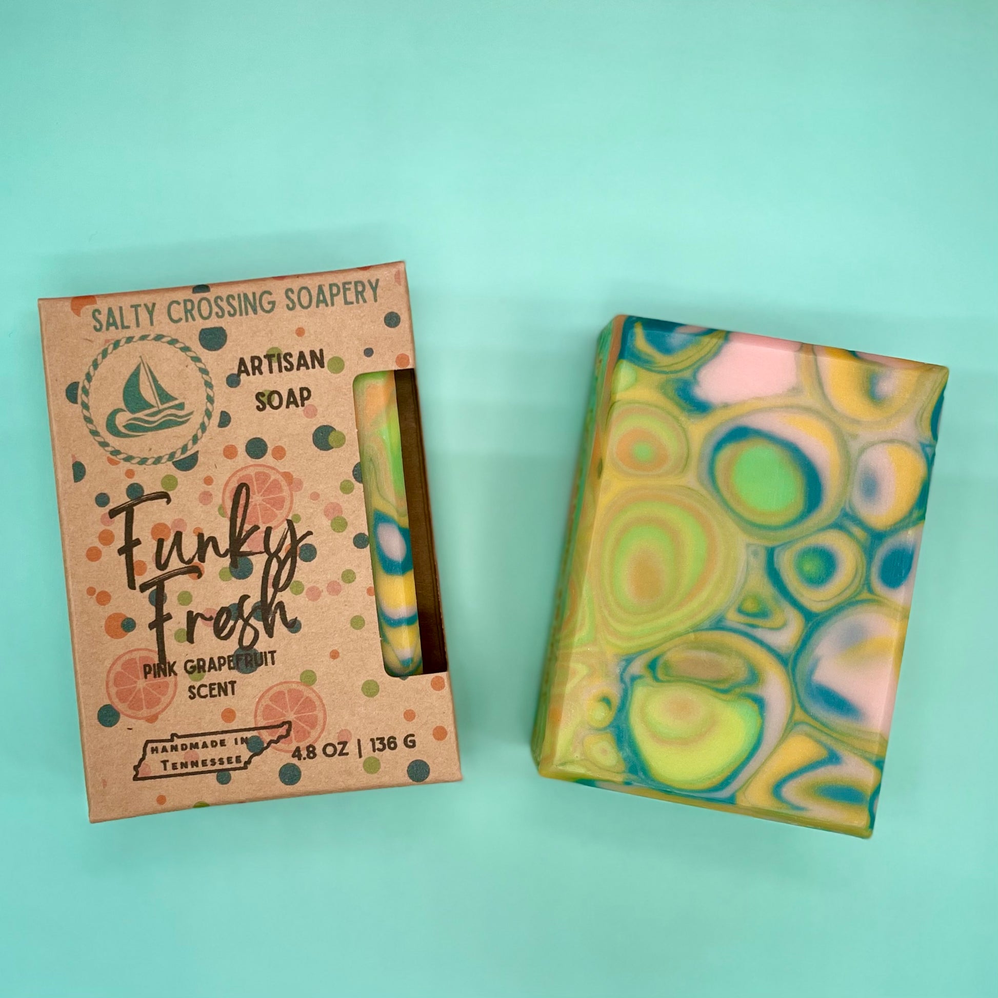 Artisan soap with a colorful packaging box on a light blue background