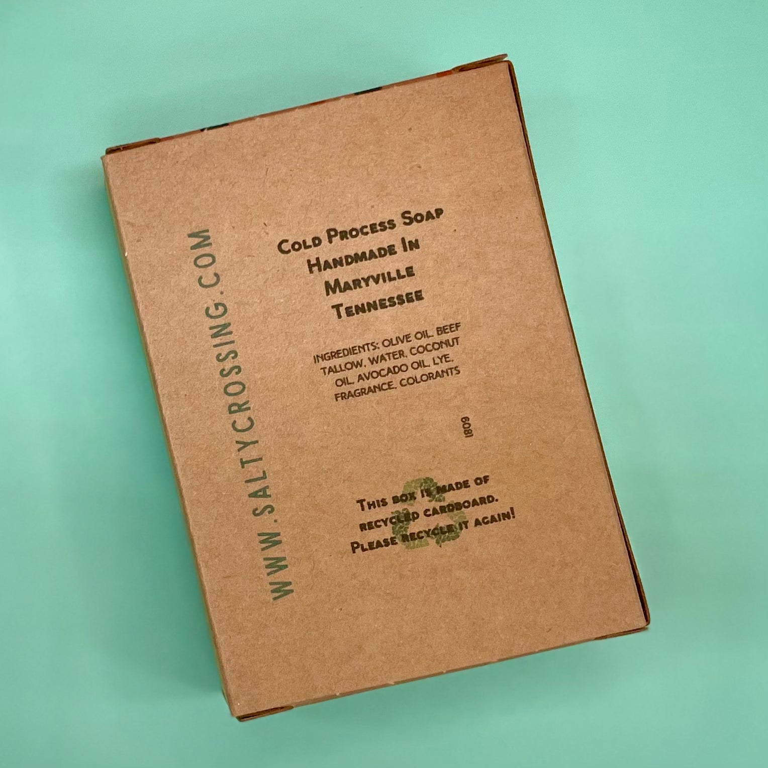 Brown cardboard soap packaging with text on a light green background