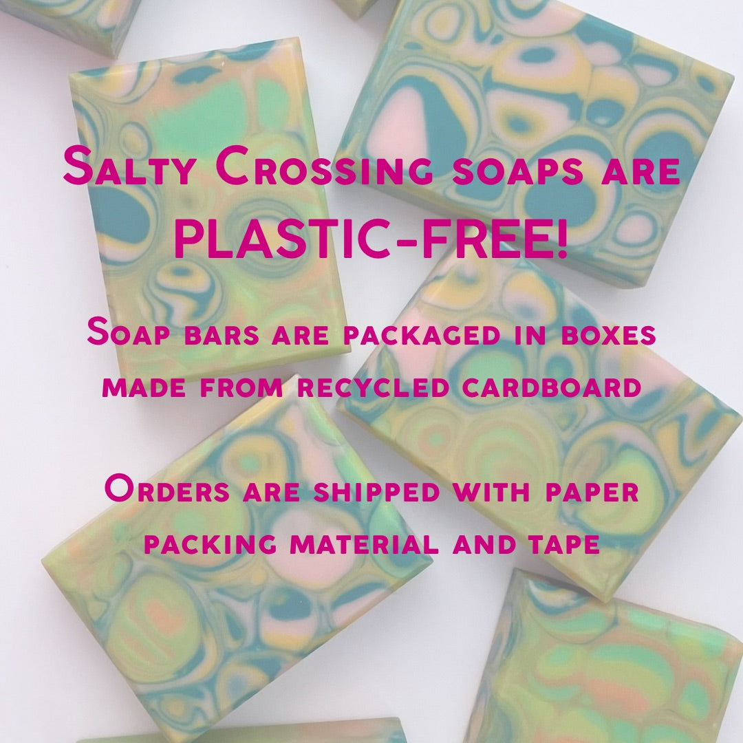 Colorful soap bars with text about plastic-free packaging on a white background