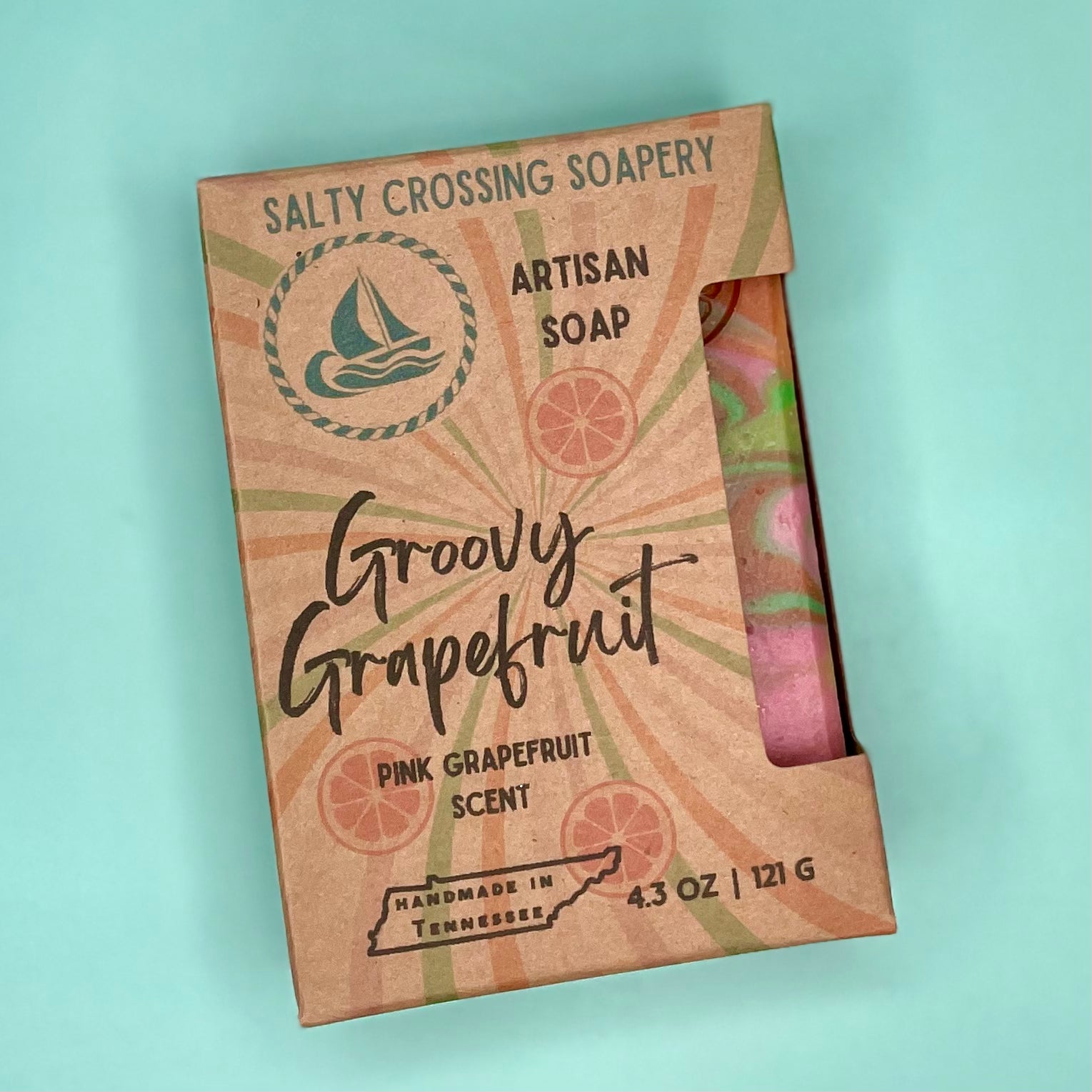 Salty Crossing Soapery artisan soap packaging with pink grapefruit scent on a light blue background