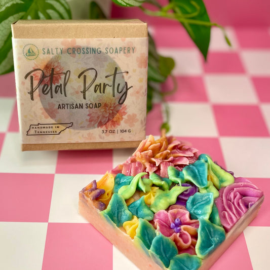 Colorful floral soap with 'Salty Crossing Soapery' packaging on a checkered background