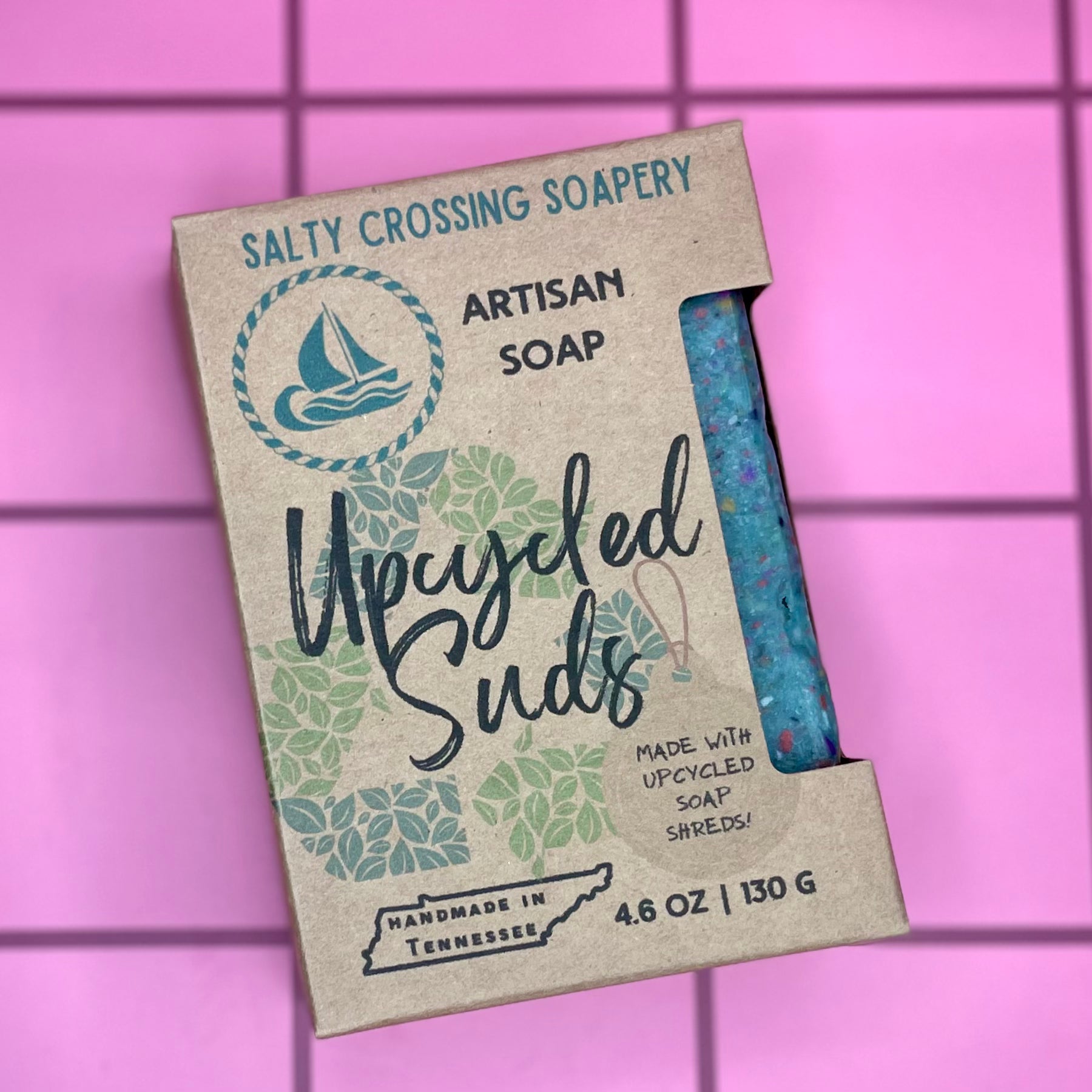 Upcycled Suds soap package with 'Salty Crossing Soapery' branding on a pink grid background