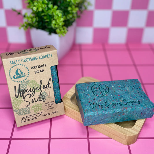 Artisan soap bar with packaging on a pink checkered background