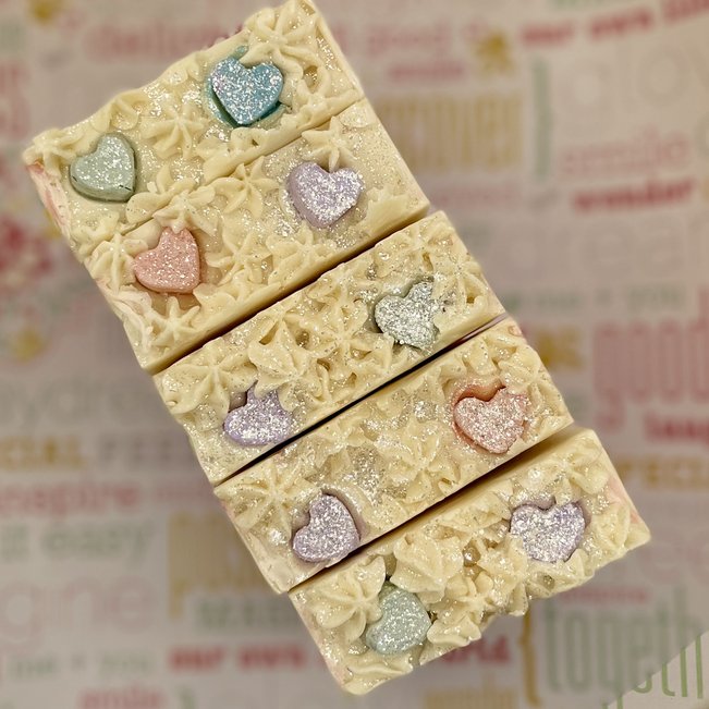 heart to heart artisan soaps. close up of candy heart shapes on soap top.