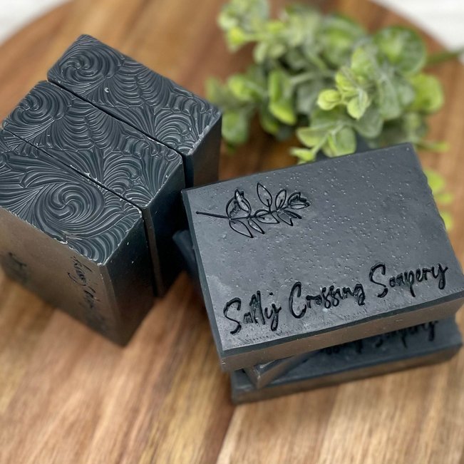 charcoal and tea tree natural goat milk soap stamped with Salty Crossing Soapery
