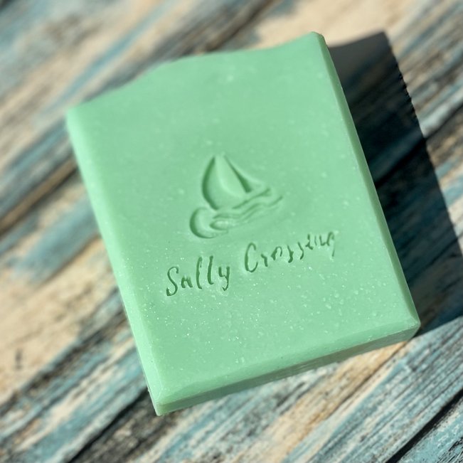 giddyup green coconut milk artisan soap. bar of light green soap with sailboat and Salty Crossing stamped on front. silver sparkles throughout the bar.