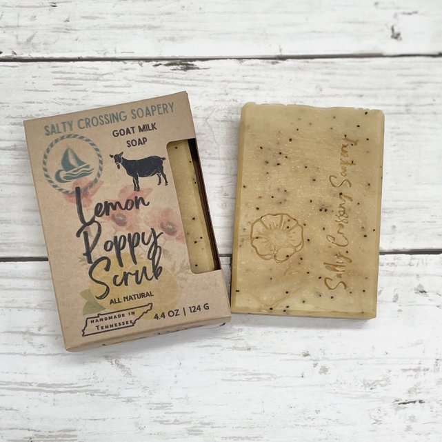 lemon poppy goat milk soap beside box. box is kraft colored with goat silhouette and handmade in Tennessee print.