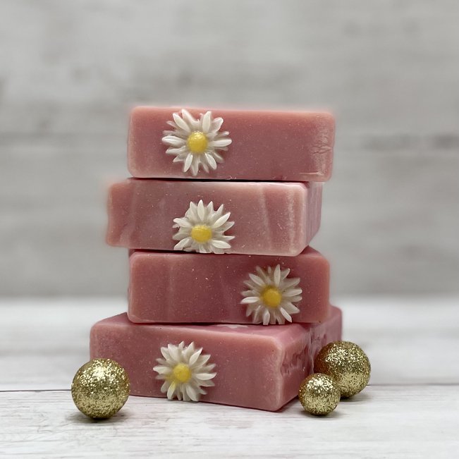 stack of pink daisy coconut milk soaps
