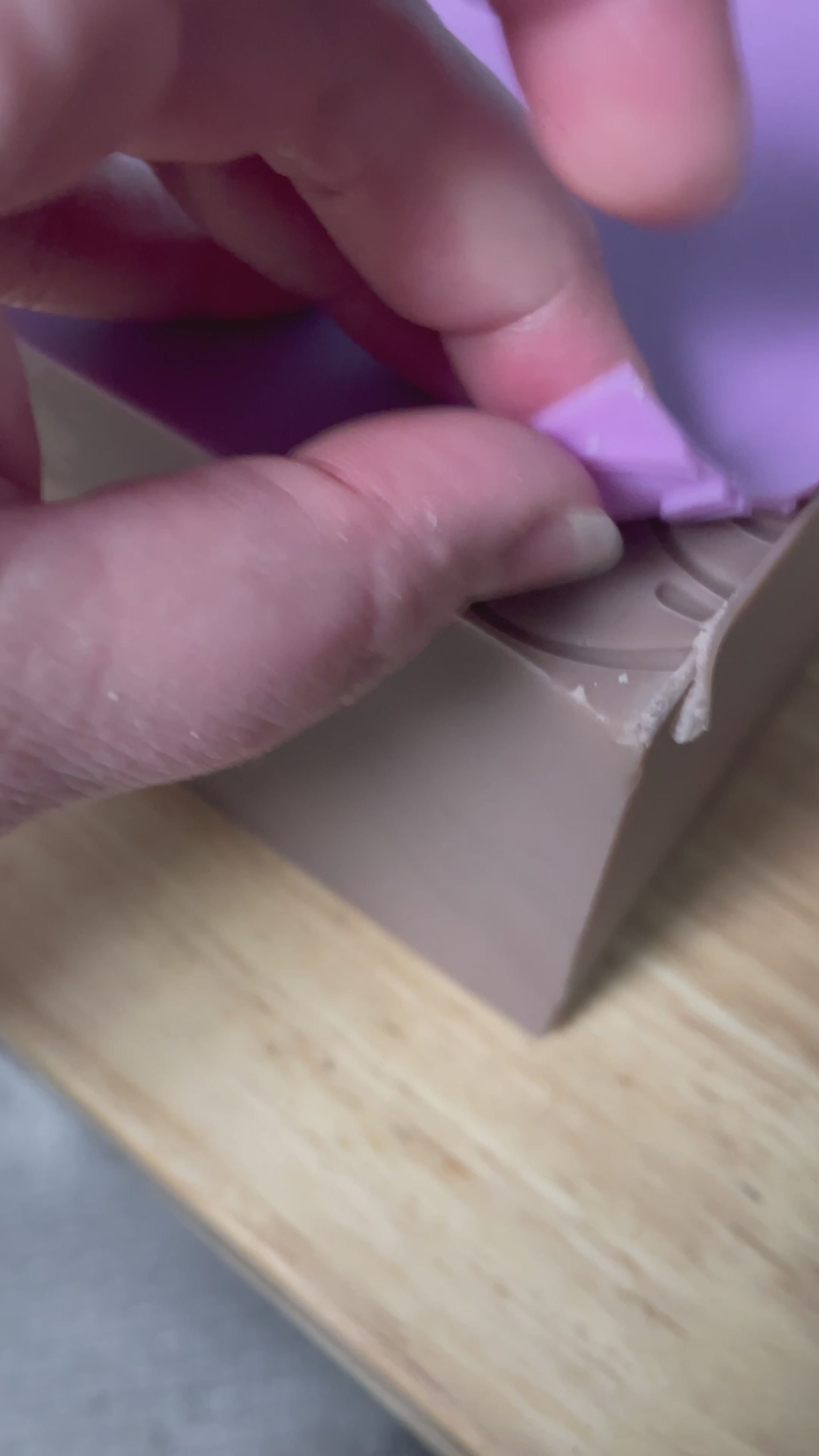 Video of peeling a texture mat off the top of lavender soap slab to show flower texture imprint