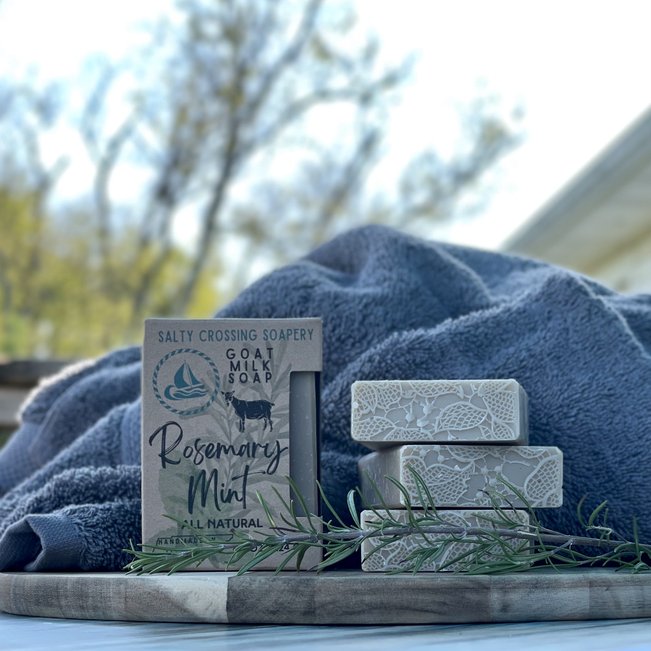 stack of rosemary mint goat milk soaps with towel
