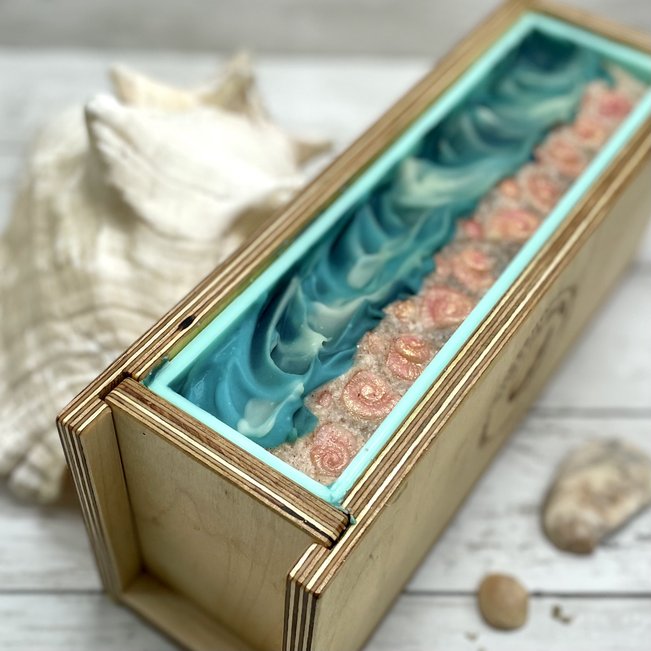coconut milk soap in mold with seashells on top