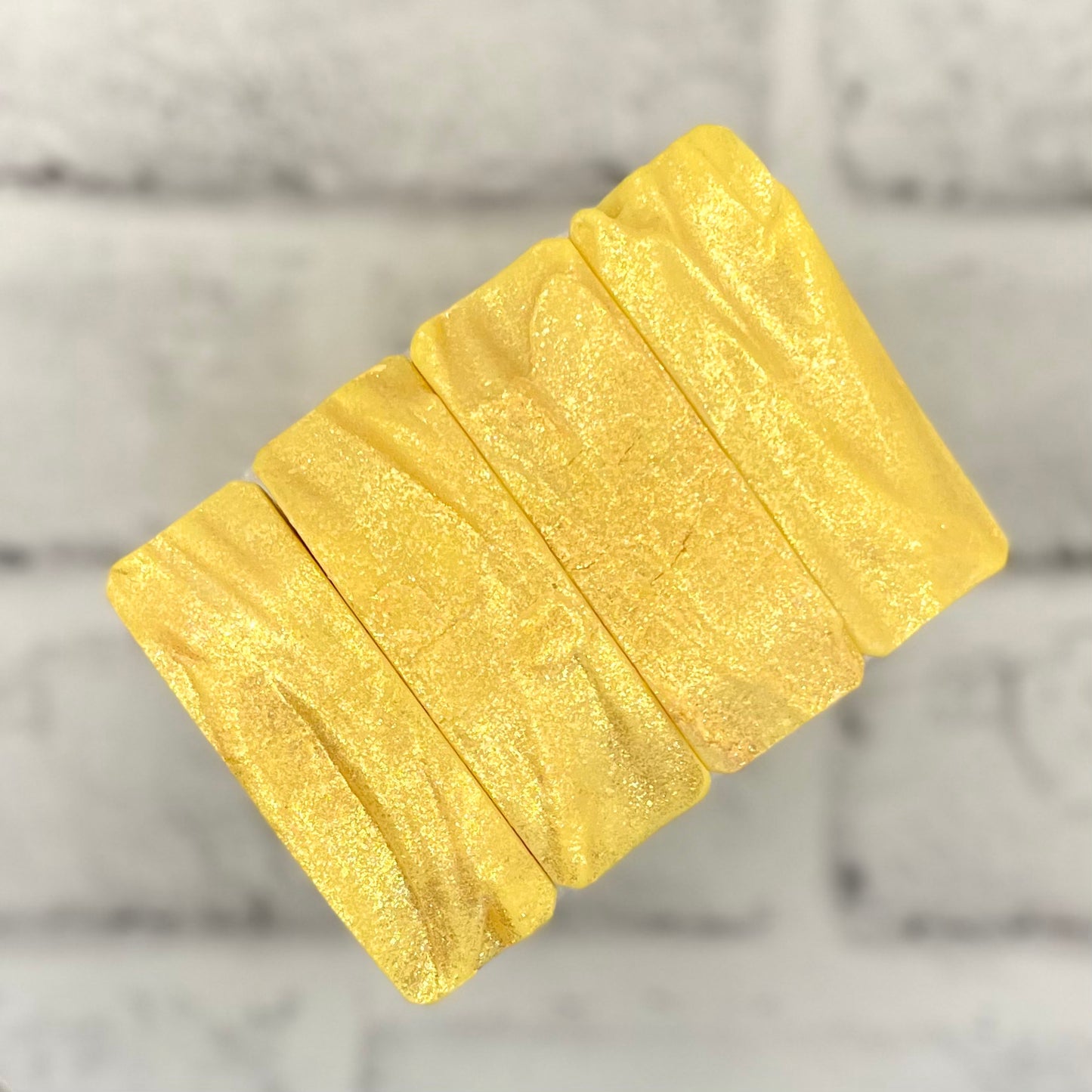 row of yellow soap tops with gold sparkles