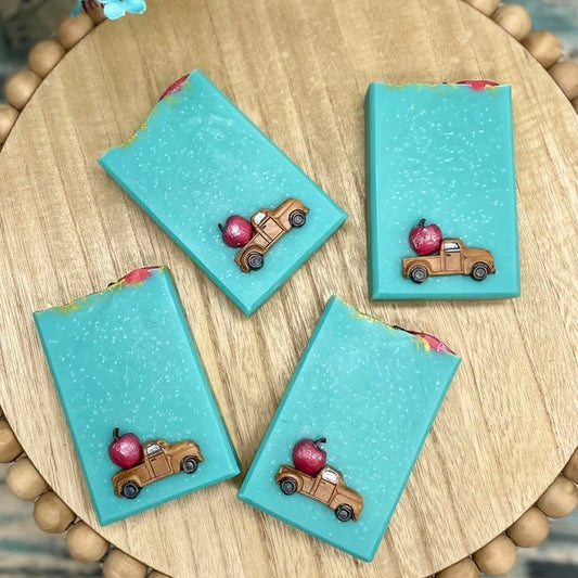blue ribbon apple artisan soap. blue soaps with brown vintage truck and giant red apple on the front.