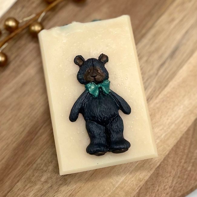 cream colored soap with black bear wearing a bow tie on the front